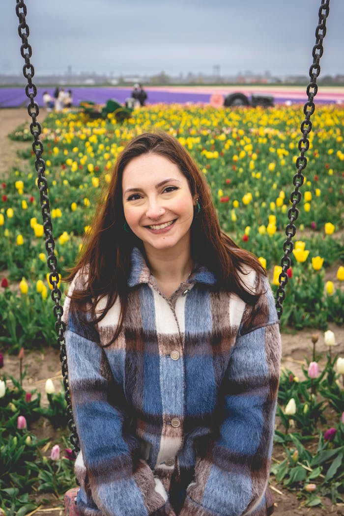 Young woman enjoying a spring day in a colorful tulip field in Hillegom, Netherlands.